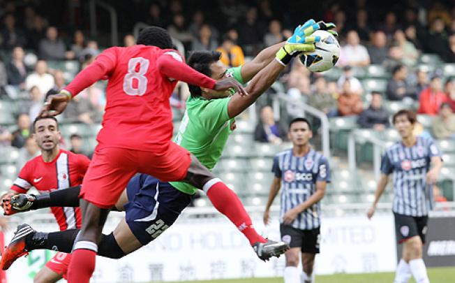 Muangthong United goalkeeper fends off a shot from one of  the Hong Kong League XI during their play-off at Hong Kong Stadium in  Causeway Bay  on Wednesday. Photo: Edward Wong