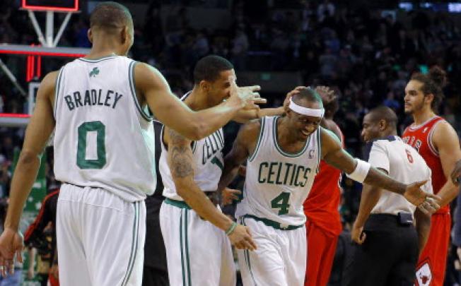 Boston Celtics' players celebrate after beating the Chicago Bulls in their NBA basketball game in Boston. Photo: Reuters