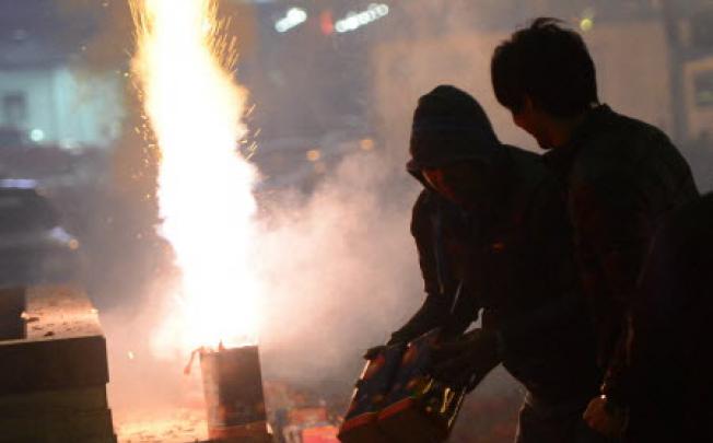 People let off fireworks in Beijing to celebrate the Chinese New Year. Photo: AFP