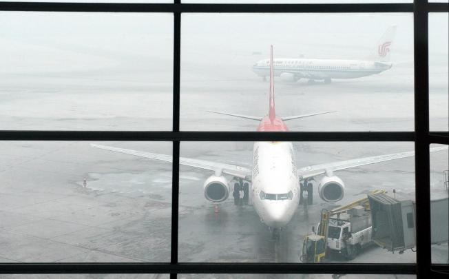 Airliners at Beijing Capital International Airport yesterday morning. Several flights were delayed by the poor visibility. Photo: Xinhua