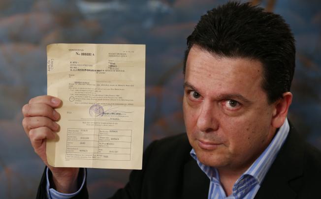 Australian Independent Senator Nick Xenophon holds up his deportation notice during a press conference after arriving back in Australia on Sunday. Photo: EPA 