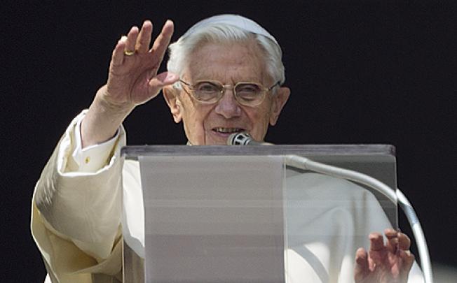 Pope Benedict XVI acknowledges a cheering crowd during his second-last Angelus prayer from the window of his apartments at the Vatican, on Sunday. Photo: AP