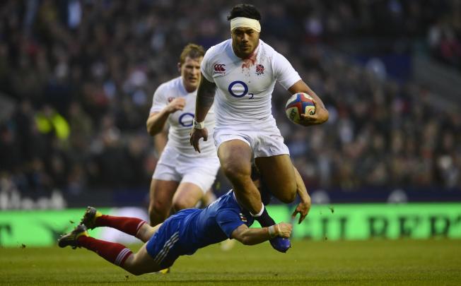 England's centre Manu Tuilagi breaks through the French defence. Photo: AFP
