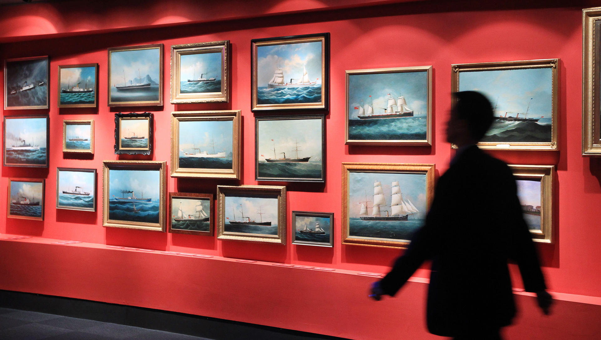 Paintings of ships on display.