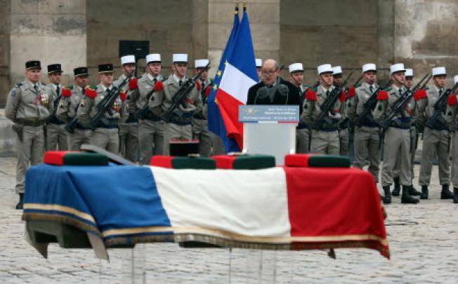 French Defence minister Jean-Yves Le Drian speaks during a ceremony in Paris for a French soldier recently killed in Mali. Photo: AFP