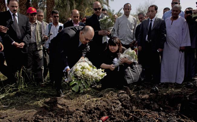 Luxor’s governor Ezzat Saad and Japanese travel agent Okumura Hatsuko pay their respects to the dead. Photo: AP