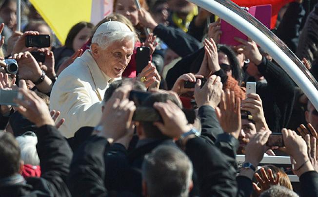 Pope Benedict XVI waves as he arrives in St Peter's Square for his last weekly audience on Wednesday. Photo: AFP 