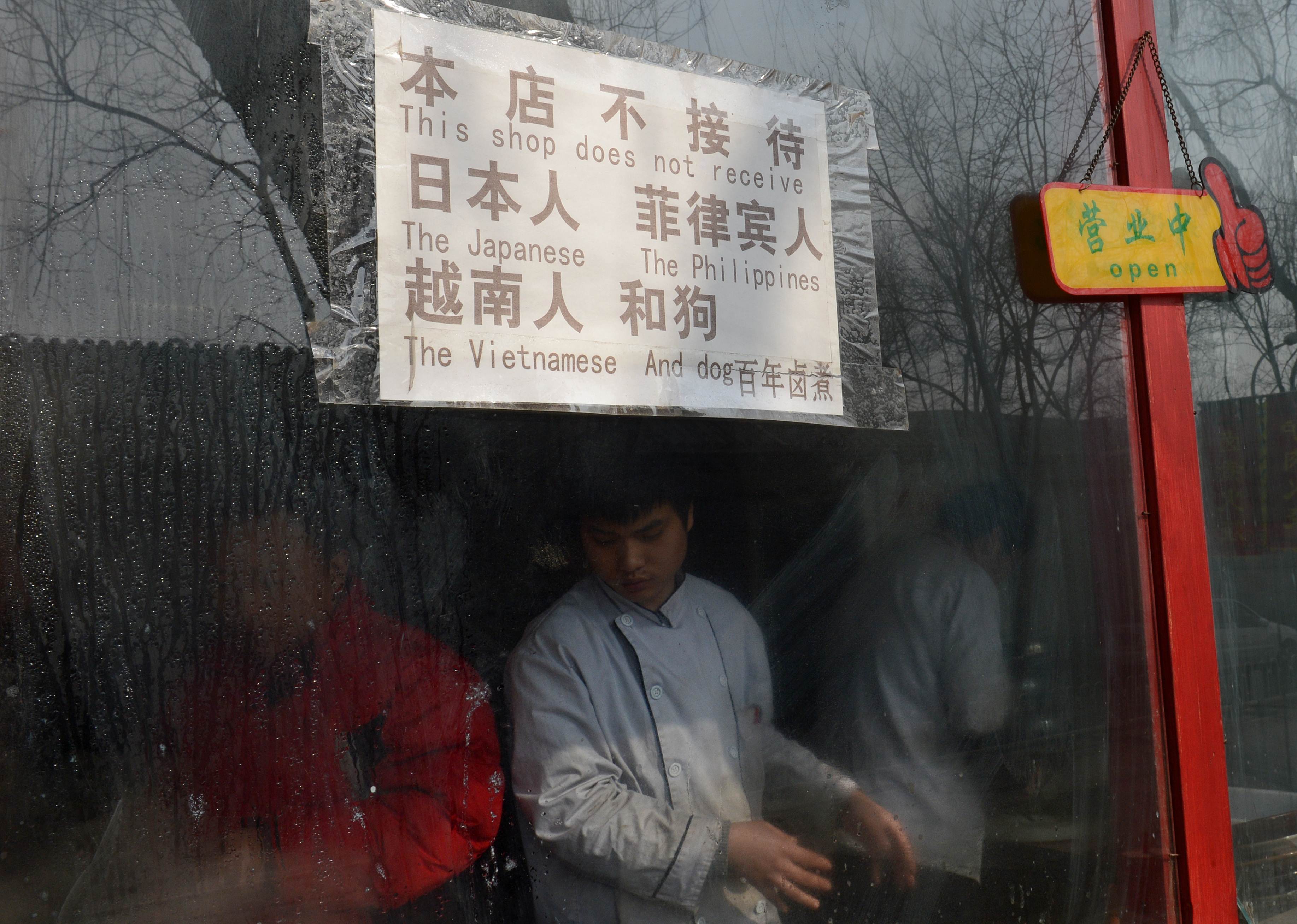 The sign in this Beijing restaurant caused an international backlash. Photo: AFP 