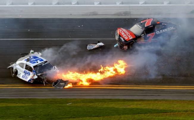 Kyle Larson, driver of the #32 Clorox Chevrolet, and Regan Smith, driver of the #7 Clean Coal Chevrolet, in an incident at the Daytona International Speedway on Sunday. Photo: AFP