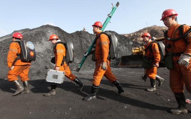 Rescuers prepare to help trapped coal miners In the southern Guangxi region in 2011. On Friday, a fire at a coal mine in northern China has killed 11. Two others are missing.