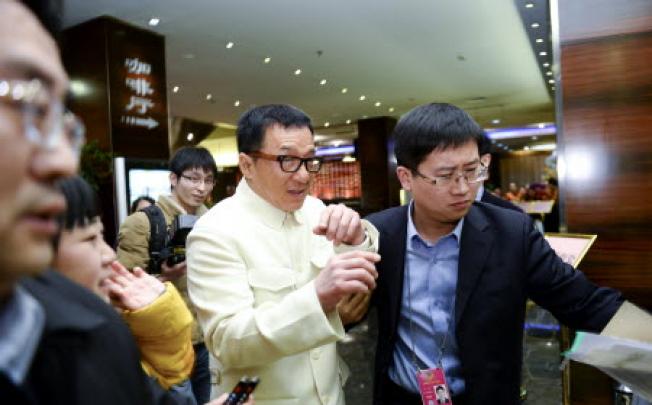 Jackie Chan arrives at the hotel served as an accommodation for the CPPCC members in Beijing. Photo: Xinhua