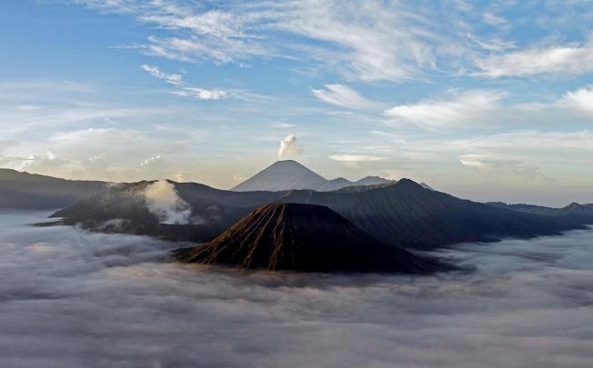 Few sights are more rewarding after a long hike than the majestic peaks of Mount Bromo and Mount Semeru (in the background) above the mist of East Java. Photos: Christian Glassl