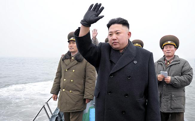 North Korean leader Kim Jong-un waves from a boat during his visit to the Jangjae Islet Defence Detachment and Mu Islet Hero Defence Detachment on the front, near the border with South Korea. Photo: Reuters