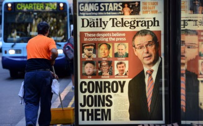 A newspaper advertising billboard in the Sydney comparing Australian Communications Minister Stephen Conroy to famous despots over his new media reforms. Photo: AFP