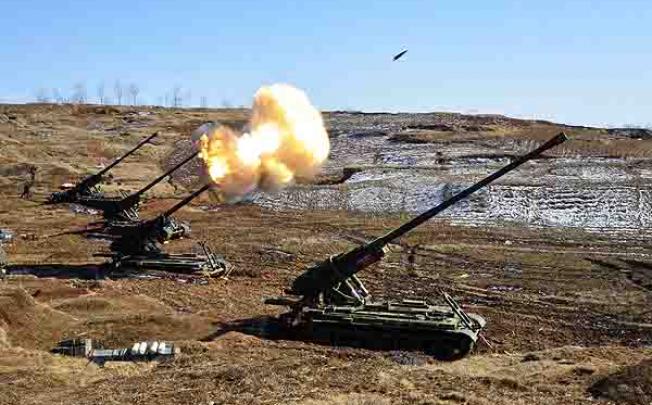 A North Korean artillery sub-unit, whose mission is to strike Taeyonphyong and Paekryong Islands of South Korea, conducts a live-firing drill. Photo: EPA