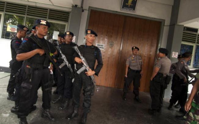 Armed police stand guard after a shooting inside the Cebongan Correctional Centre in Yogyakarta on Saturday. Photo: AFP