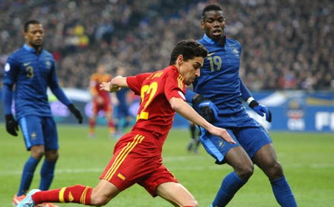 Spain's midfielder Jesus Navas (centre) beside France's midfielder Paul Pogba (right) during the World Cup 2014 qualifying football match France vs Spain on Tuesday in Saint-Denis, outside Paris. Photo: AFP 