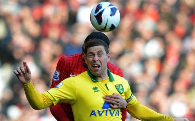 Norwich City's English striker Grant Holt vies with Manchester United's English defender Chris Smalling. Photo: AFP