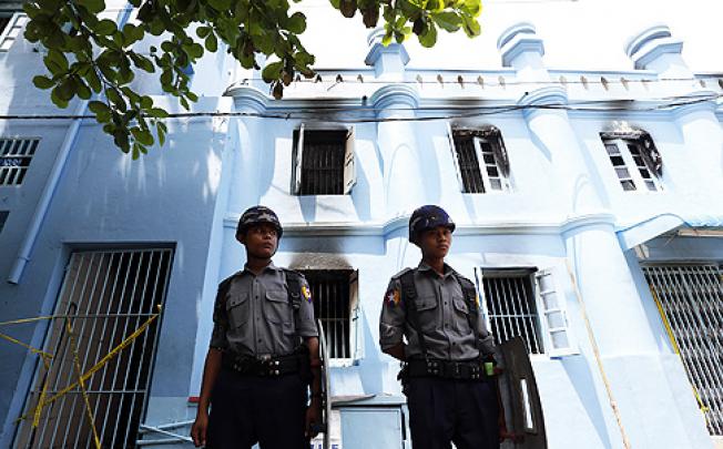 Myanmar policemen stand guard in front of a mosque school after a fire broke out in Yangon, killing 13, on Tuesday. Photo: Xinhua