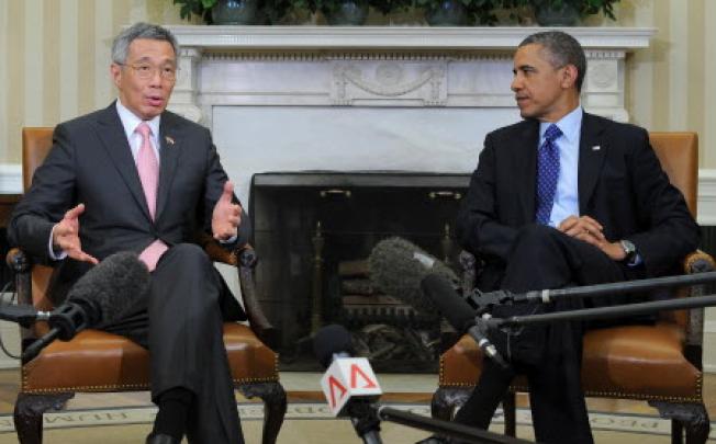 US President Barack Obama (R) listens as Singapore’s Prime Minister Lee Hsien Loong speaks to the media before their bilateral meeting in the Oval Office at the White House in Washington, DC. Photo: AFP