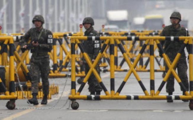 South Korean soldiers patrol as vehicles returning from North Korea's inter-Korean Kaesong Industrial Complex back to South Korea arrive at a checkpoint on the Grand Unification Bridge in Paju. Photo: Reuters