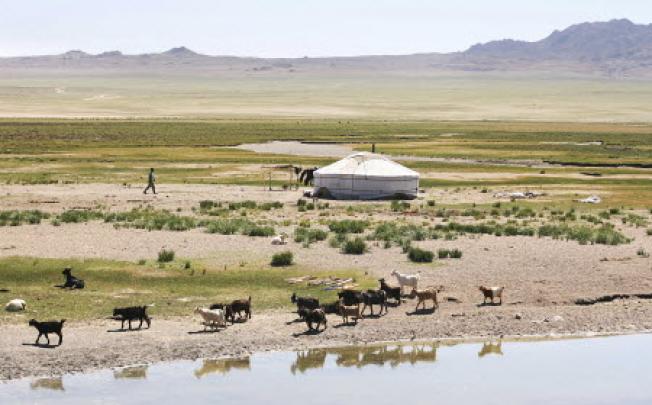  In Mongolia's Gurvansaikhan National Park, the Camel Lodge (left) offers guests luxuries and spa treatments in yurts, which traditionally house Mongolia's nomadic herders (above) in the Gobi Desert. Photo: SCMP pictures