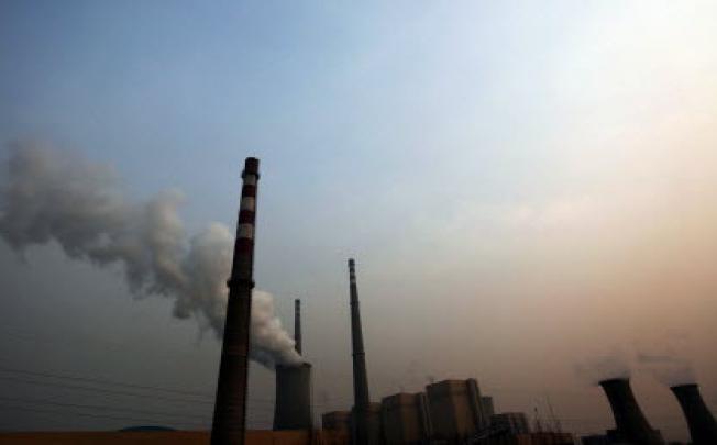 A power plant as the sun sets in Beijing. China is feeling the man-made heat of global warming. Photo: EPA