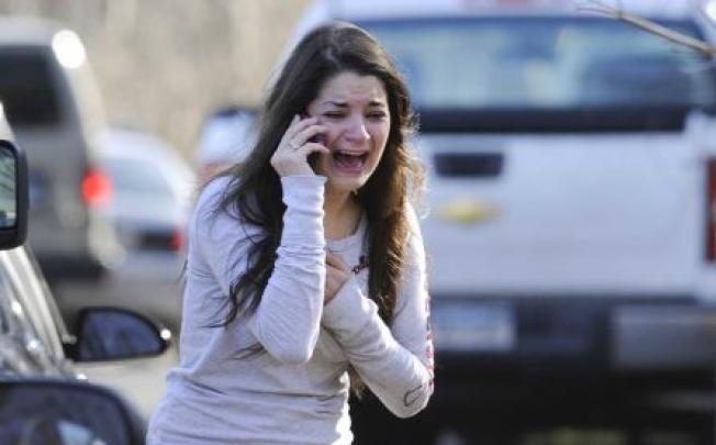 A distraught woman seeks information about a relative during last year's Sandy Hook Elementary School in Newtown, Connecticut. Photo: AP 