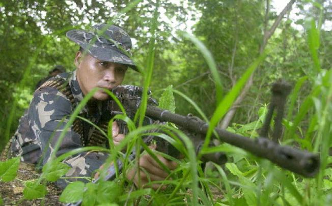 A Filipino soldier keeps a close watch for Abu Sayyaf rebels. Two Abu Sayyaf commanders have survived the latest Philippine military offensive which killed eight militants. Photo: Reuters