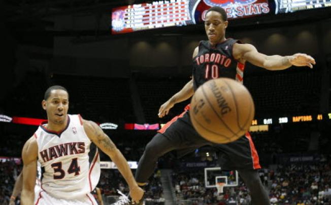 Atlanta Hawks Devin Harris watches as Toronto Raptors DeMar DeRozan loses the ball in their NBA game in Atlanta. Photo: Reuters
