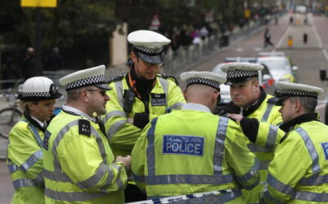 British police officers gather near the Mall in central London. > Britain is increasing police numbers by 40 per cent for Sunday’s London marathon. Photo: AP