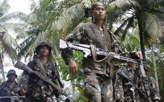 Philippine soldiers in action against rebels in Mindanao. Philippine rebels are raking in millions of dollars extorting money from election candidates, an official said on Sunday. Photo: AFP.