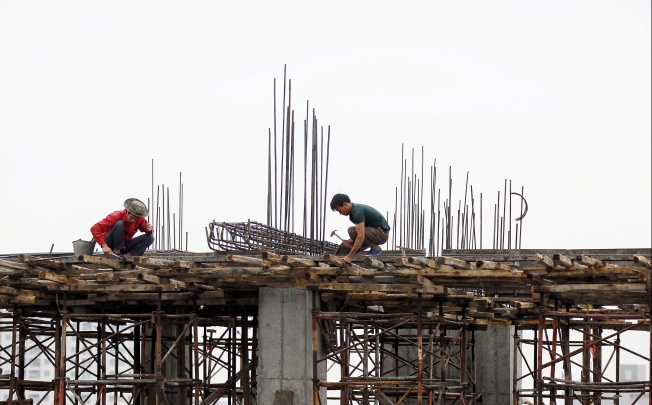 Workers at a construction site in Hanoi, Vietnam. Vietnam is one of the frontier markets that are opening up. Photo: EPA