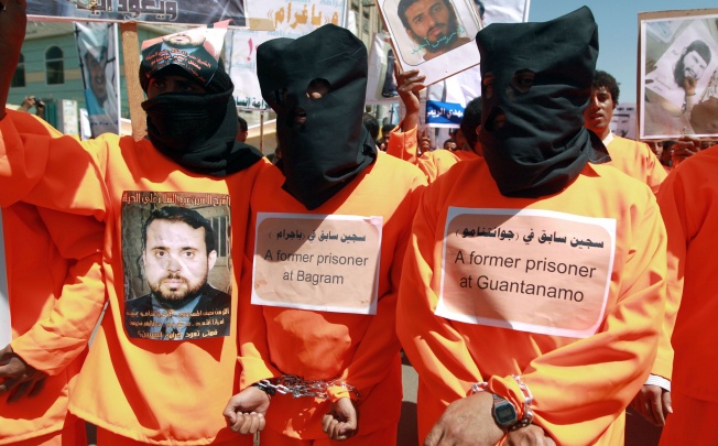 Yemenis wearing orange jumpsuits, similar to those worn by prisoners at the US detention centre in Guantanamo Bay, hold a protest demanding the release of inmates on hunger strike. Photo: AFP
