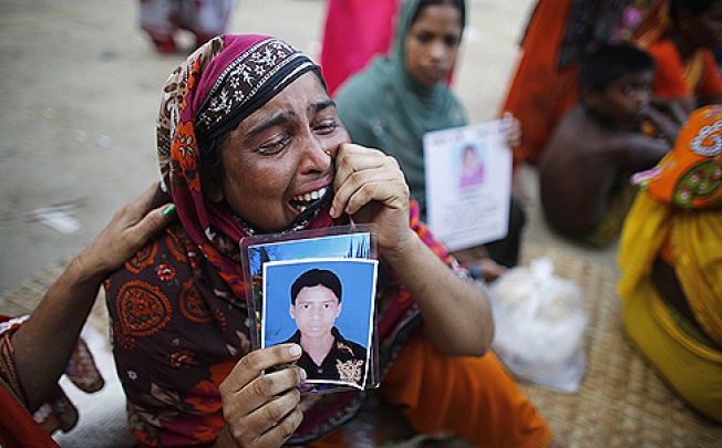 A woman cries as she waits for news of her relative, a garment worker who is still missing, after the collapse of the Rana Plaza building in Savar, outside Dhaka. Photo: Reuters