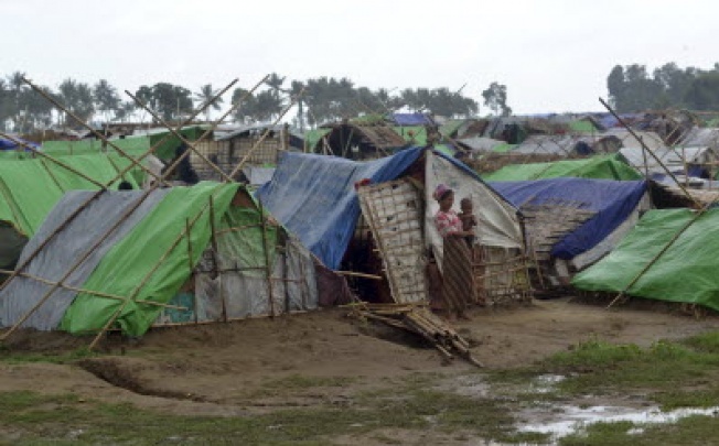 A woman outside the makeshift tented refugee camp in Sittwe, western Myanmar, on Wednesday. A mass evacuation is occurring in coastal areas of Myanmar due to approaching cyclone Mahasen. Photo: AP