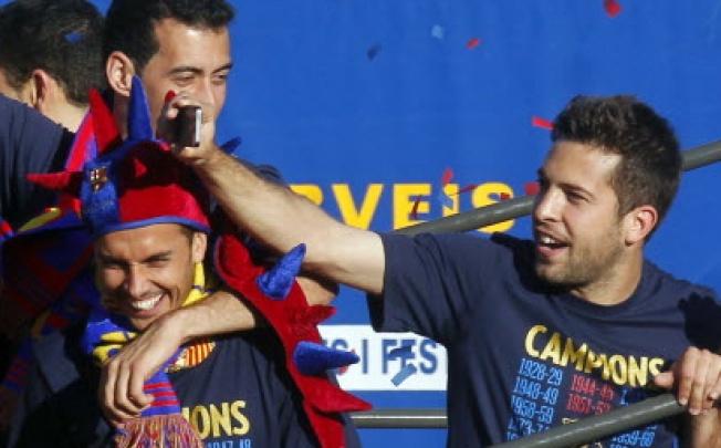 Barcelona's players Pedro Rodriguez, Sergio Busquets (top) and Jordi Alba (right). Rodriguez has claimed he and his teammates are targeting Real Madrid’s league record of 100 points after sealing the title last weekend. Photo: Reuters