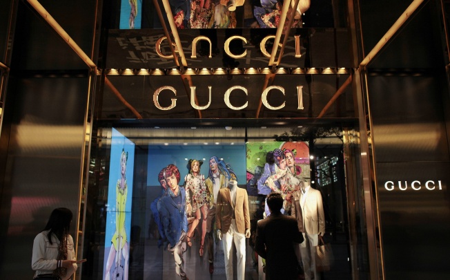 A man watches in front of a window display outside a Gucci store in Hong Kong January 17, 2013. Photo: Reuters