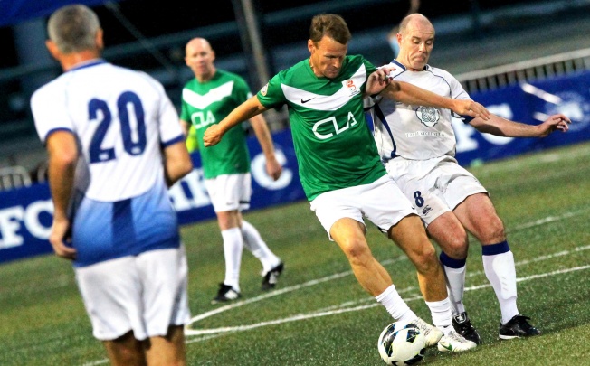 Teddy Sheringham of CLA Discovery Bay is challenged by Graham Lane of HKFC Chairman's Select during the Sevens last night at Football Club. CLA won 1-0. Photo: Edward Wong