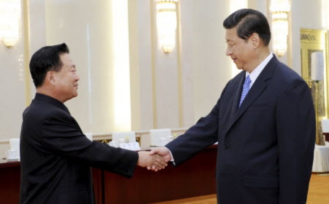 Chinese President Xi Jinping, right, greets North Korean Vice Marshal Choe Ryong Hae in Beijing. Photo: AP