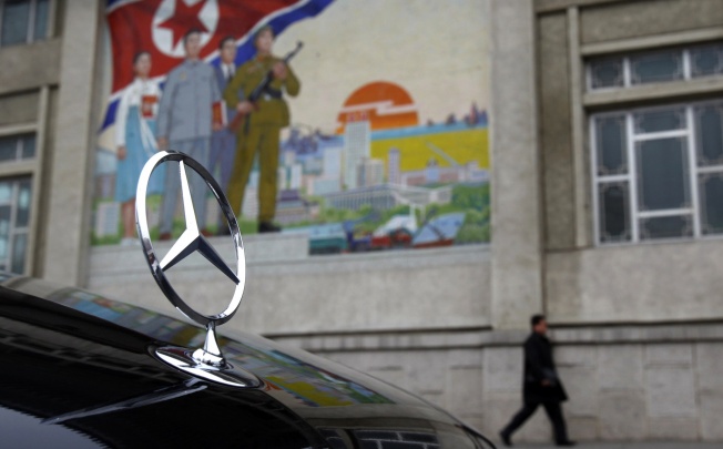 A Mercedes-Benz car parked outside the People's Cultural Palace, Pyongyang. Photo: Reuters