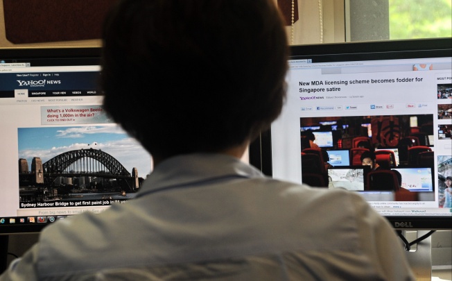 A person browses through media websites on a computer in Singapore. Photo: AFP
