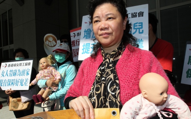 Chiu Man, Member of Hong Kong Women Workers' Association and other members protests against the neglect of women's needs in government policies outside Central Government Offices in Tamar. Photo: Dickson Lee