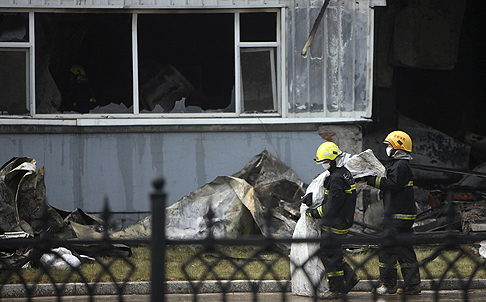 Firefighters outside the poultry slaughterhouse. Photo: Reuters