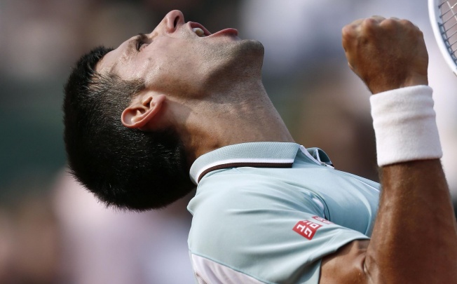 Novak Djokovic celebrates after beating Germany's Tommy Hass in the French Open quarter-final. Photos: AFP