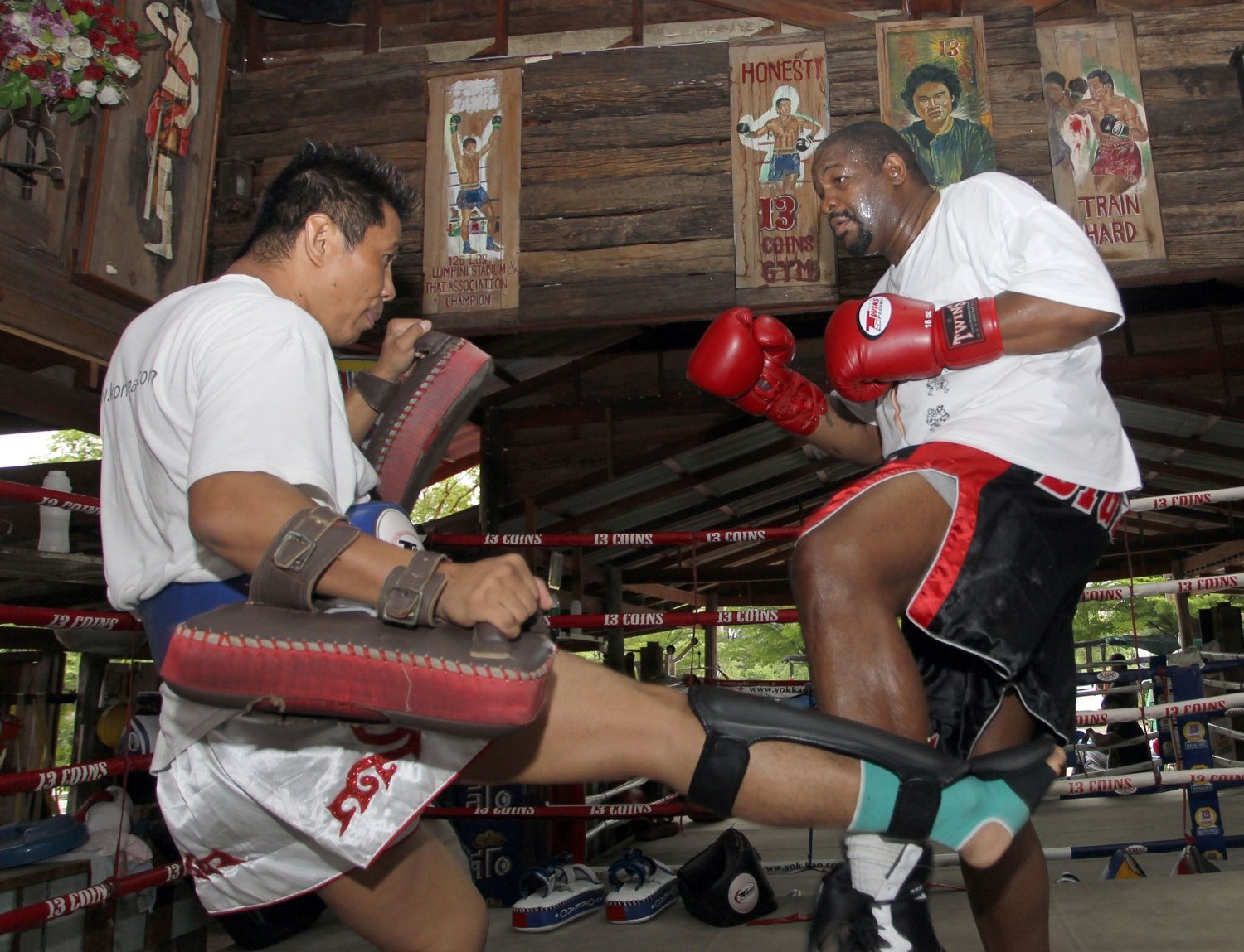 Former world heavyweight boxing champion Riddick Bowe of the US, right, trains a Muay Thai with his Thai partner at a gym in Bangkok, Thailand. Photo: AFP