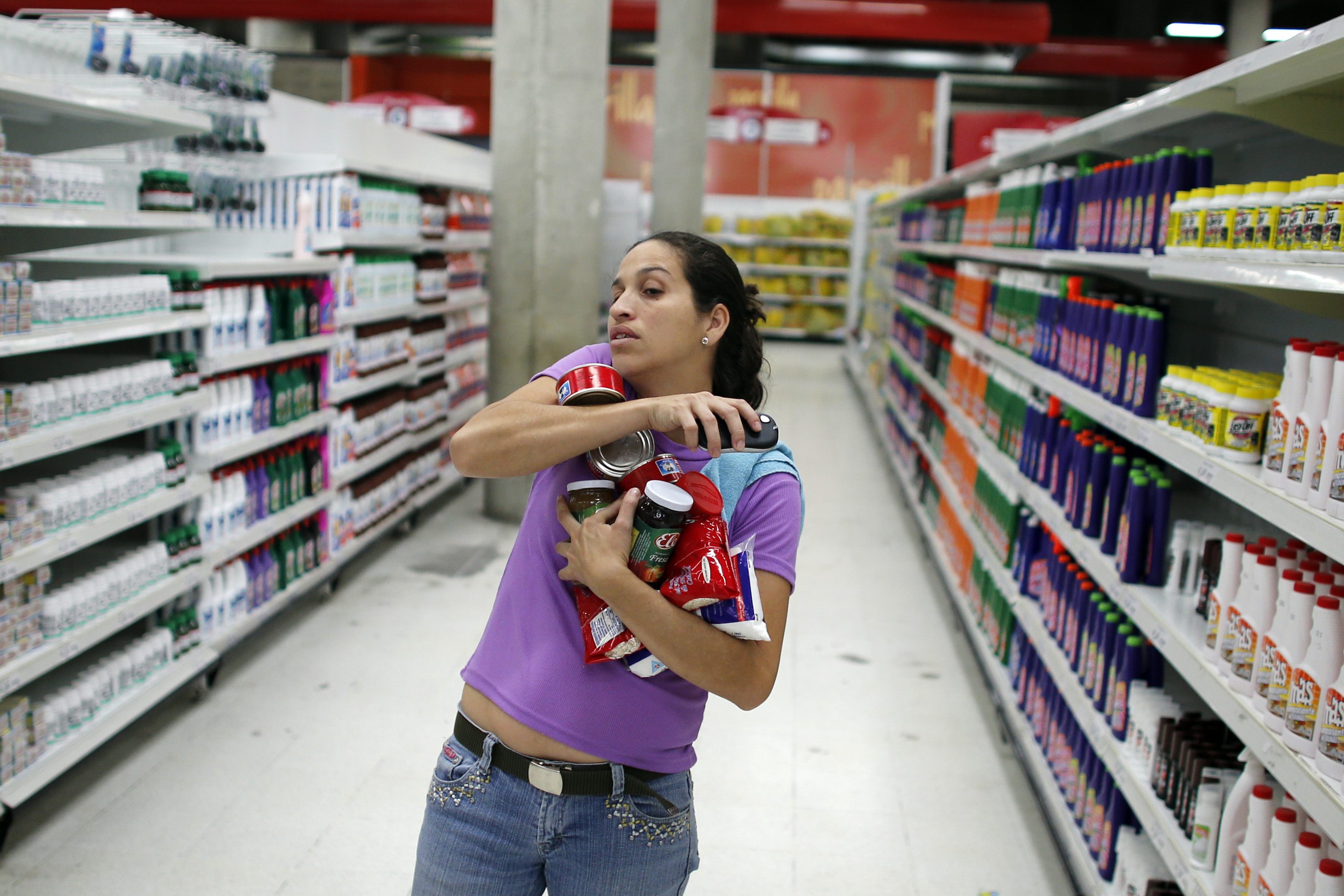A shopper carries grocery items at state-run Venezuelan supermarket 'Bicentenario' in Caracas. Photo: Reuters