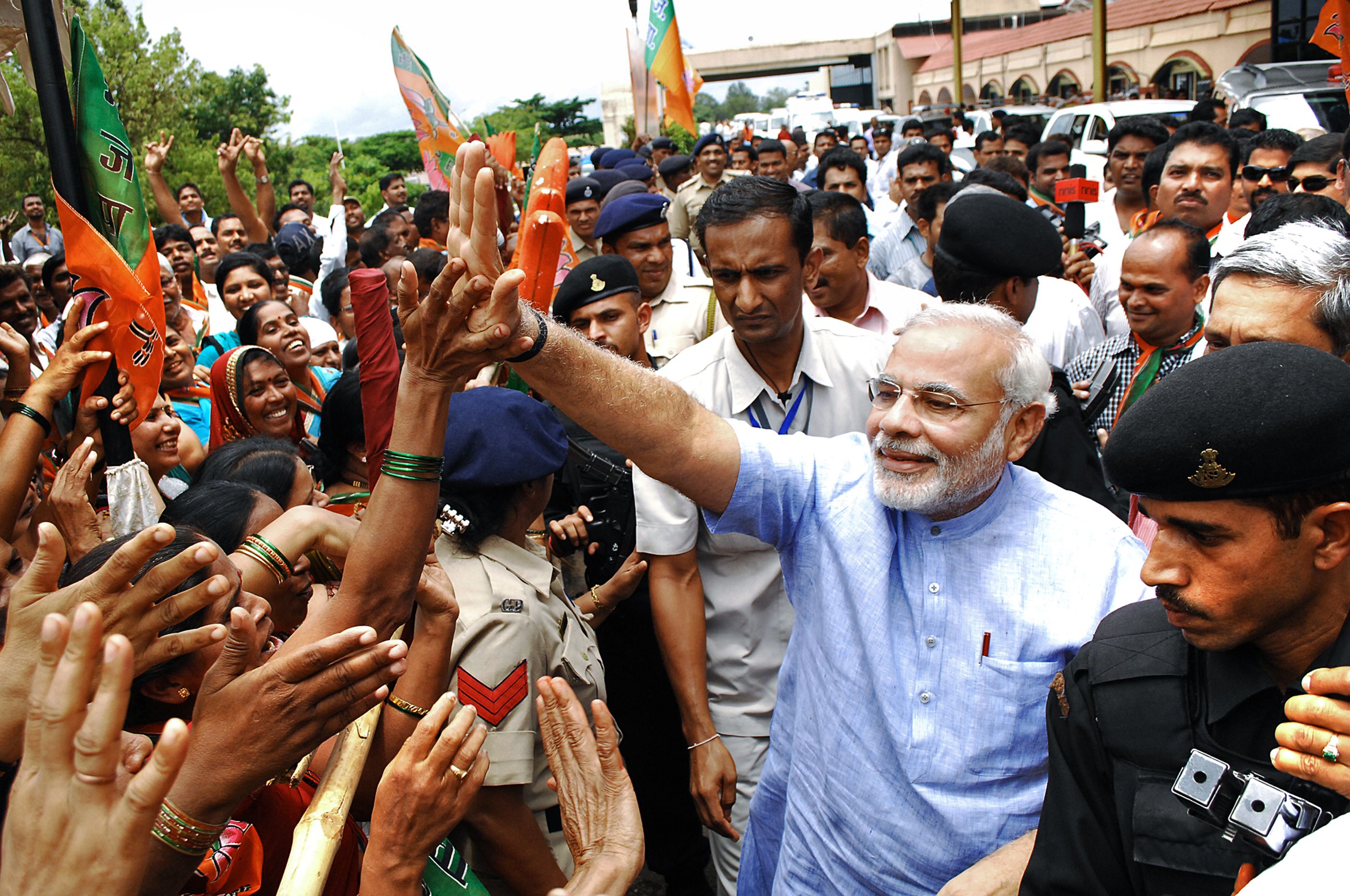 Narendra Modi (in blue) greets supporters upon arrival in Goa on Friday. Photo: AFP