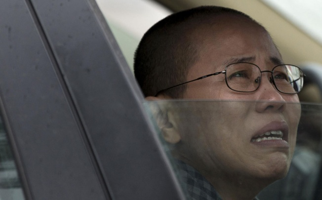 Liu Xia, wife of imprisoned Nobel Peace Prize winner Liu Xiaobo, weeps in anguish after her brother was jailed yesterday. Photo: AP