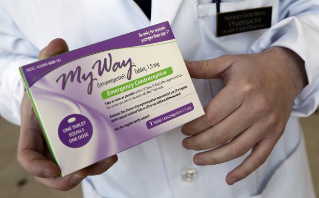 A pharmacist holds a generic emergency contraceptive, also called the morning-after pill. Photo: AP